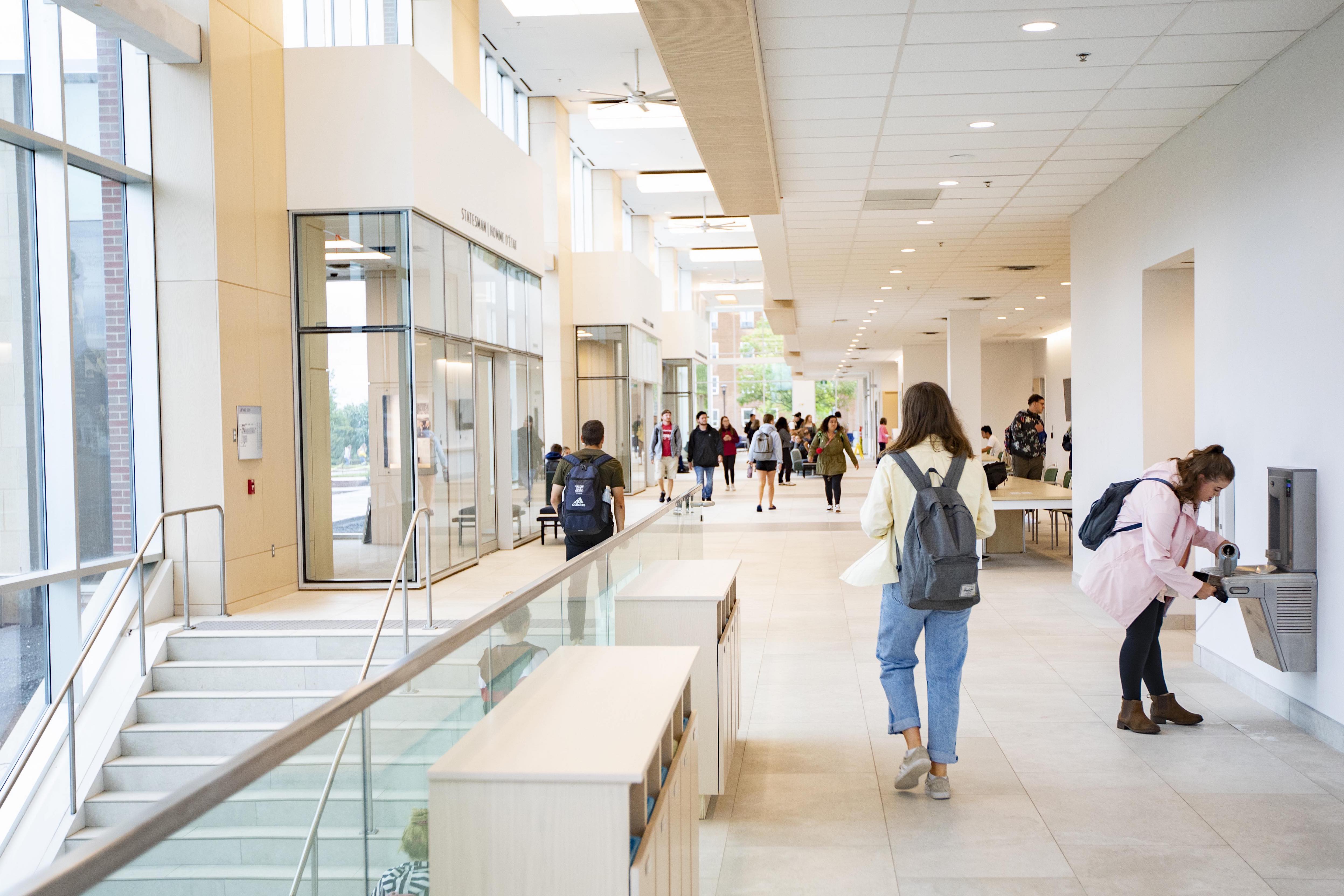 Student walking through Scholars Walk in Mulroney Hall