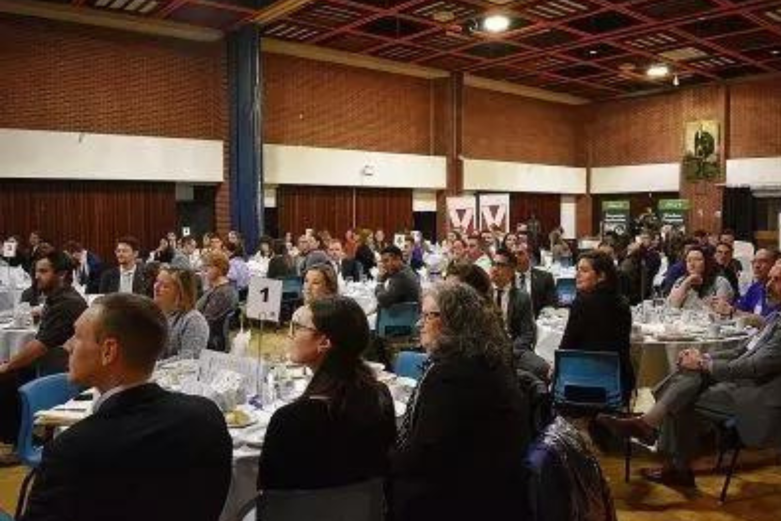People sitting at round tables in the MacKay Room