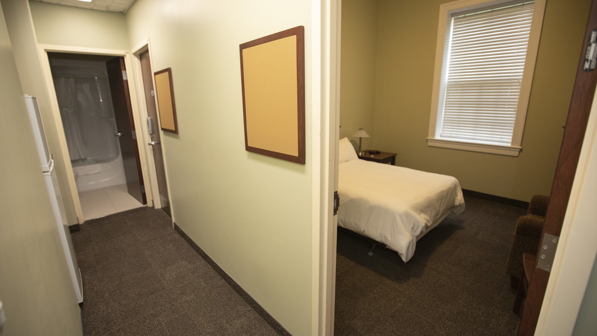 Governors Hall double suite, showing one of two rooms, a kitchen and a bathroom at the end of the hall.