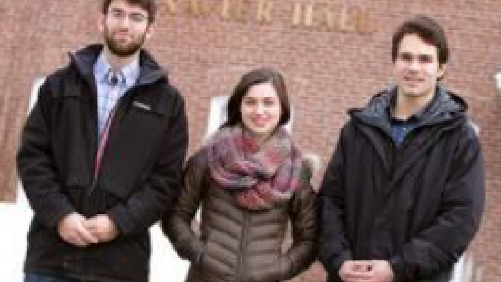 Three people standing together 