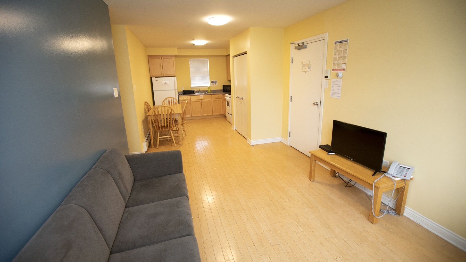 Apartment style residence located in Power and Somers Hall. Includes a kitchen, dining table and living room.
