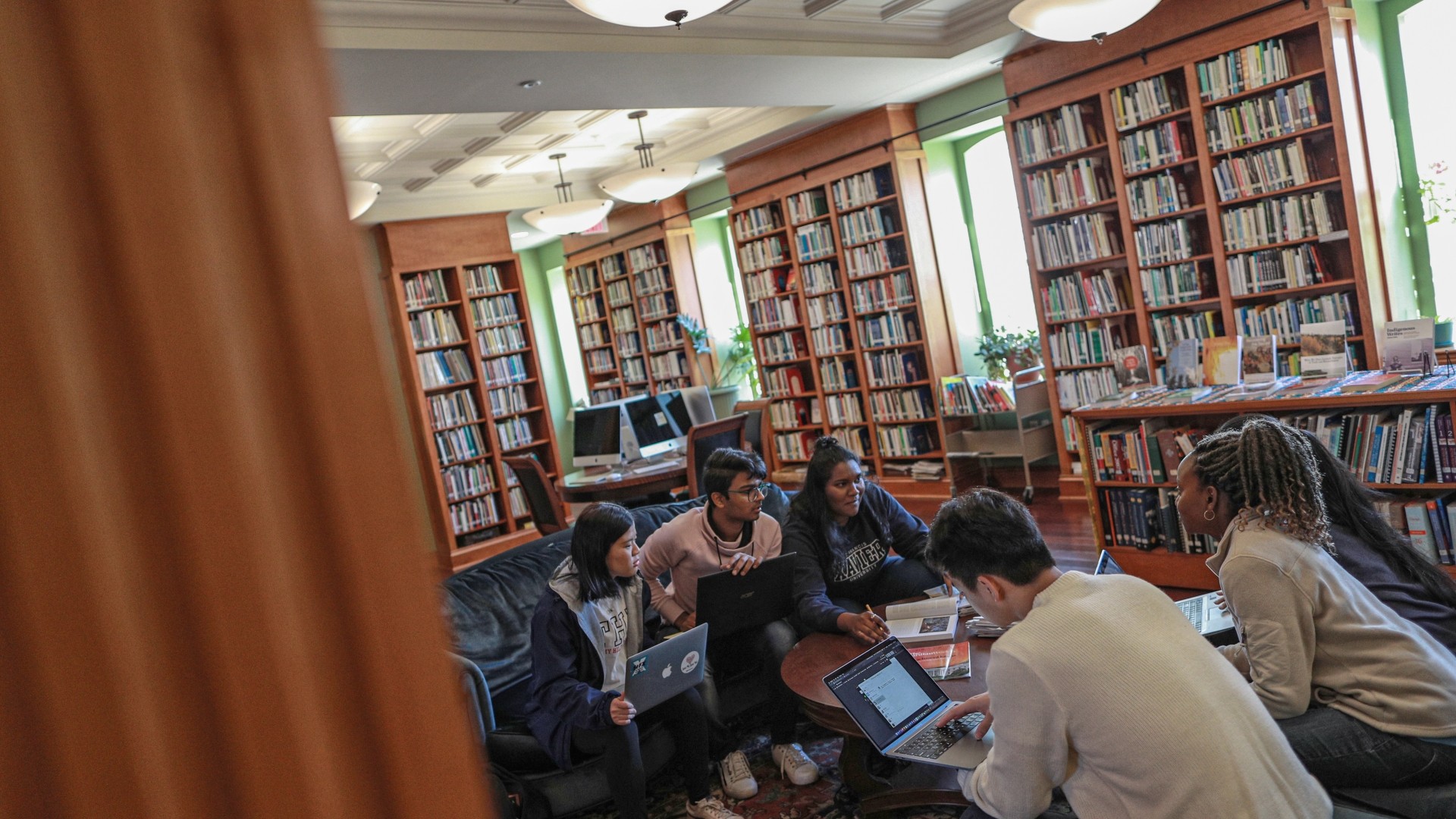 Students studying while sitting on couches in the Coady International Institute library.