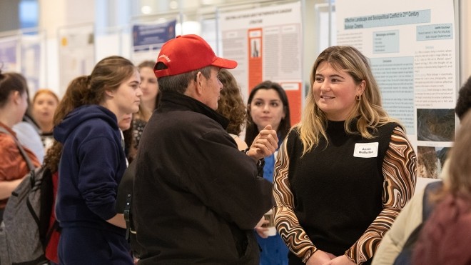 Students talking to each other in a crowd