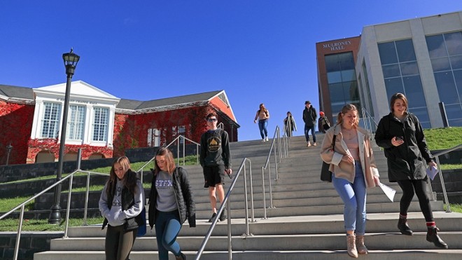 Students walking down steps in front of Mulroney Hall and Angus L. Library.