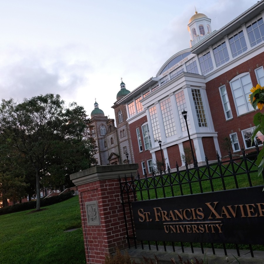 The StFX sign outside of Schwartz and the McKenna Centre as the sun is setting