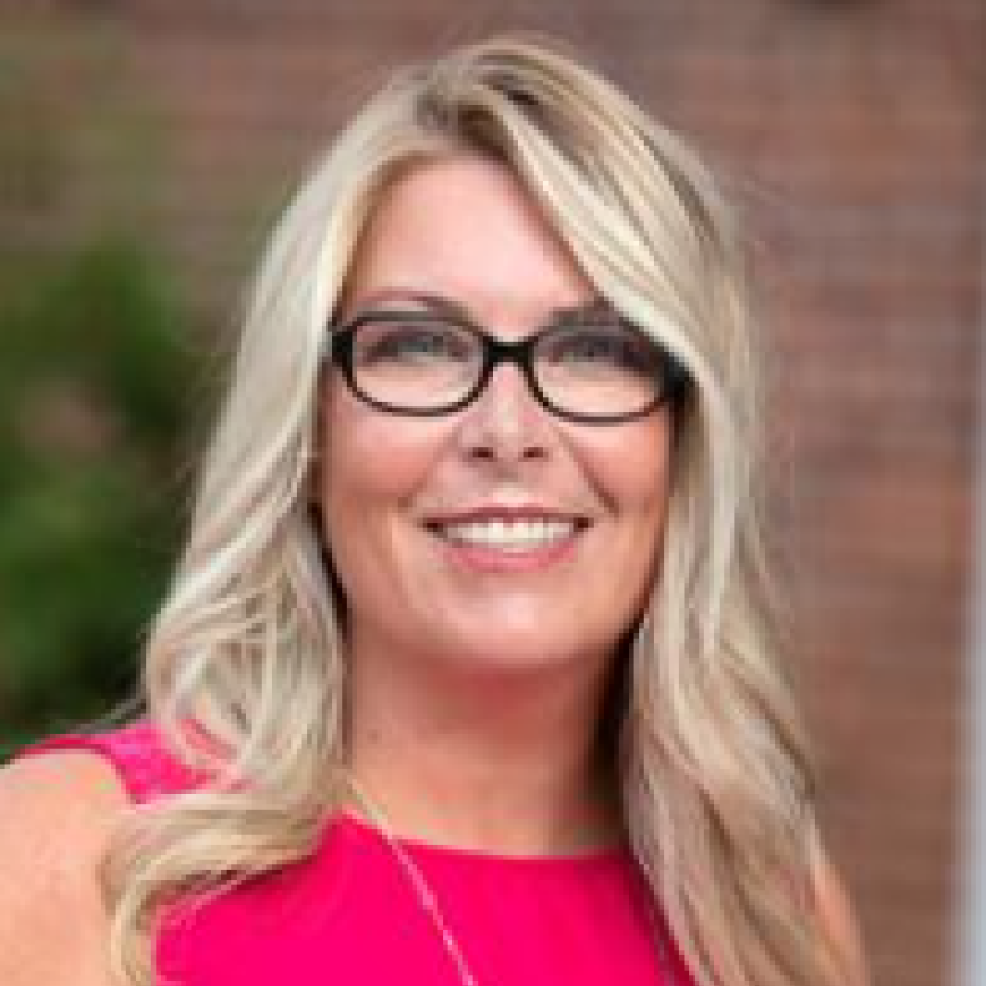 Headshot of woman with long blonde hair and glasses 
