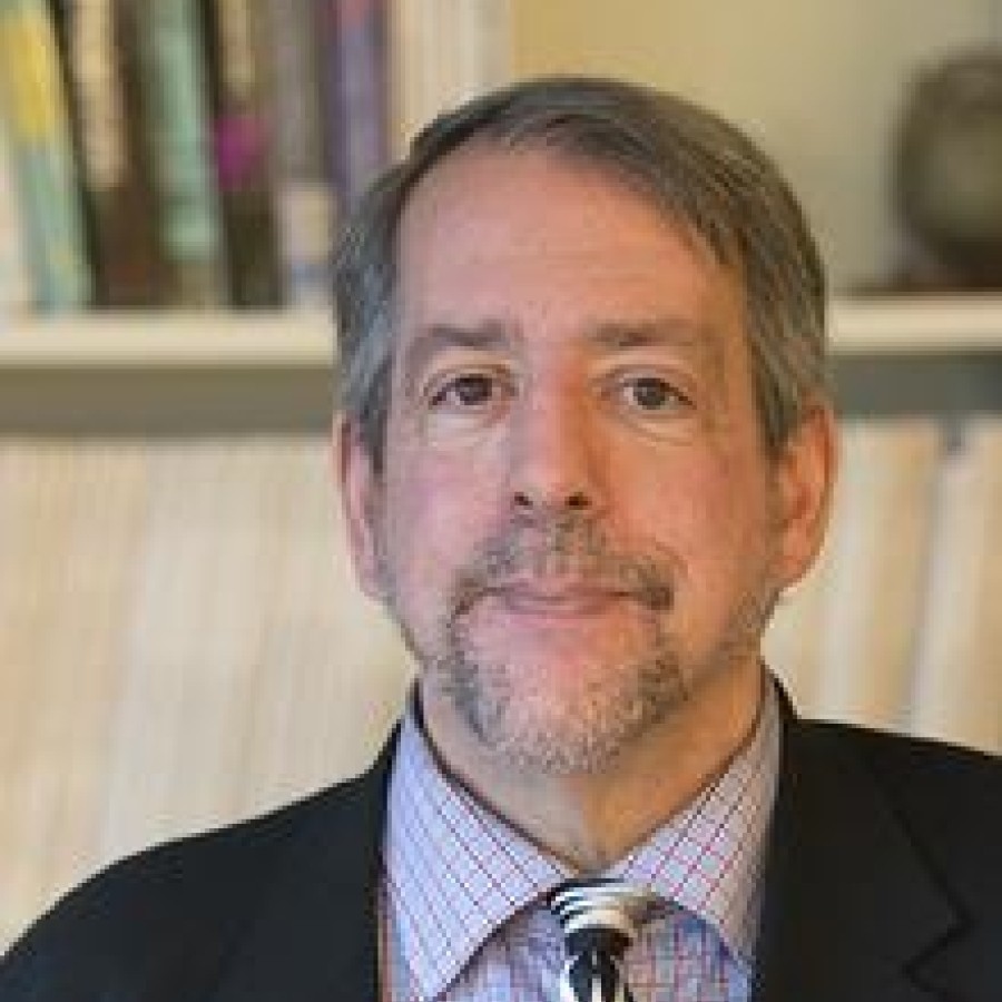 A person in front of a bookcase