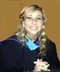 Kayla Cotton in a graduation gown smiling for the camera