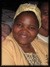 Dr. Ottilia Chareka wearing a yellow hat and smiling