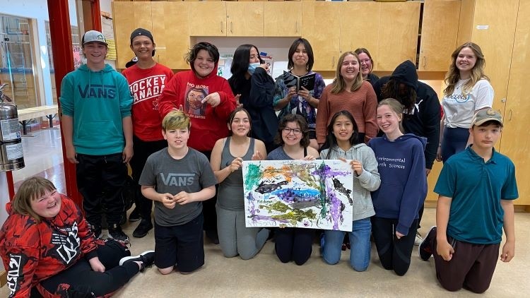 Outreach class holding up a poster