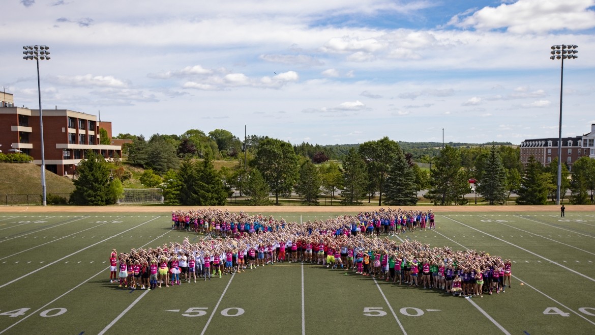 Students forming a giant X