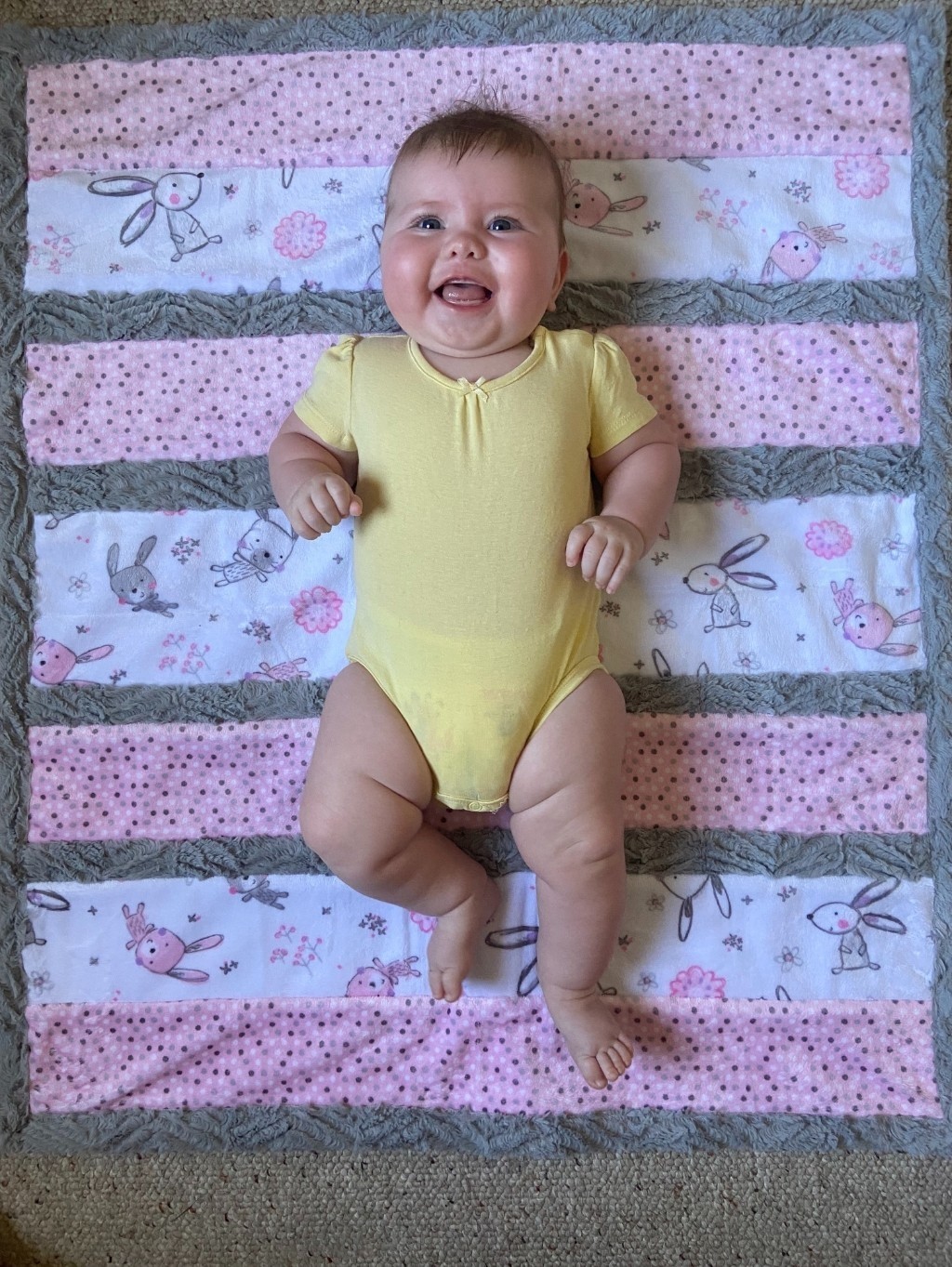 A baby lying on a blanket