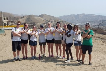 Group of people posing on desert background