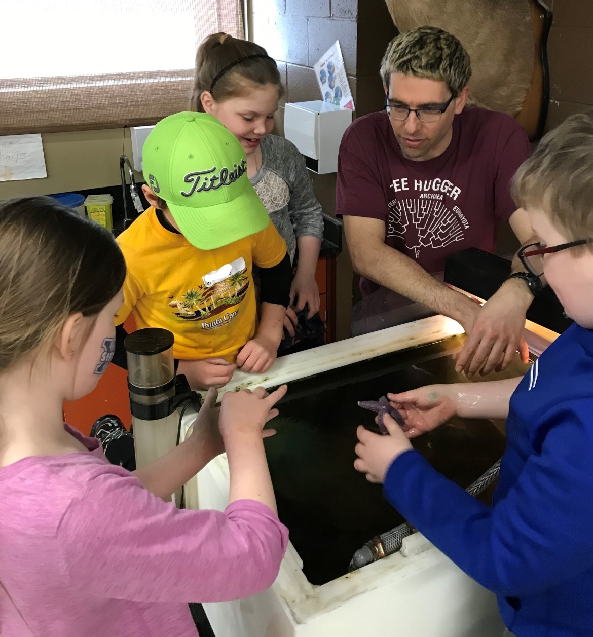 Teacher Instructing School Students About Starfish