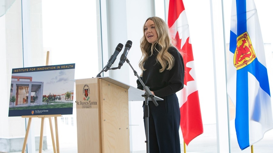 Dr. Britney Benoit standing at a podium