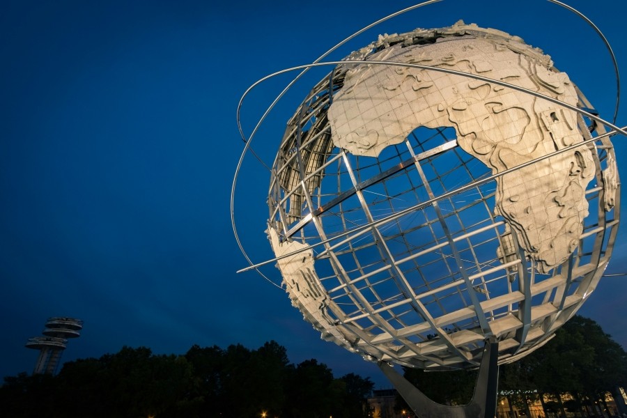 Gold metal globe highlighted against the night sky.