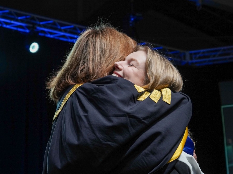 Graduating Student Hugging Mila Mulroney 