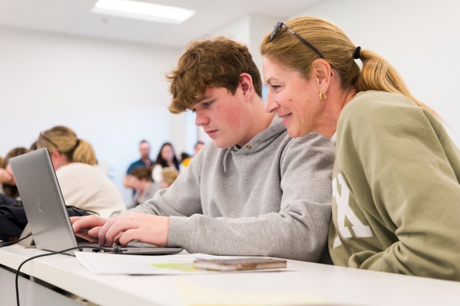 Student and their parent at the application station during the StFX Open House