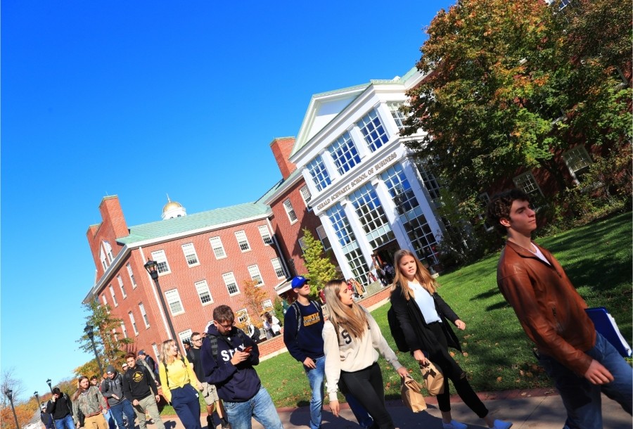 Students Walking outside on a sunny day, leaving the Gerald Schwartz School of Business