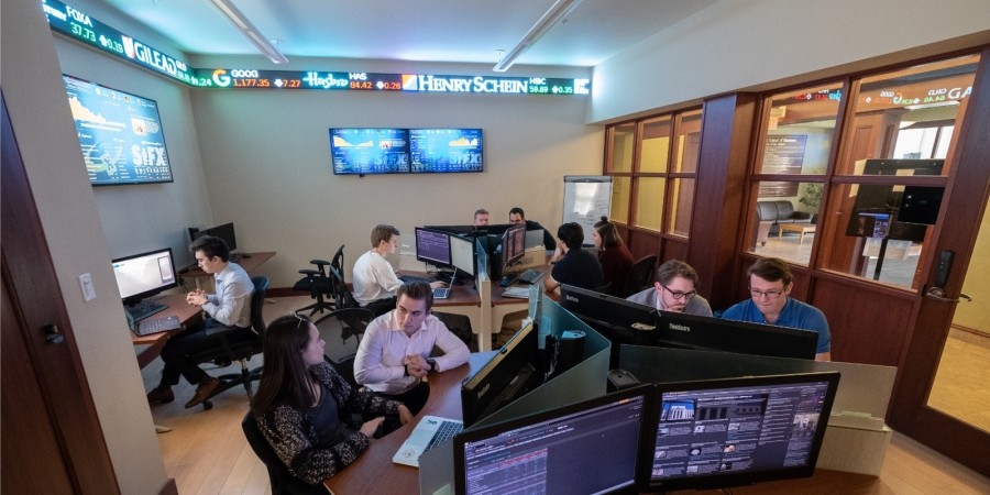 Business students studying in the trading room in the Gerald Schwartz School of Business.