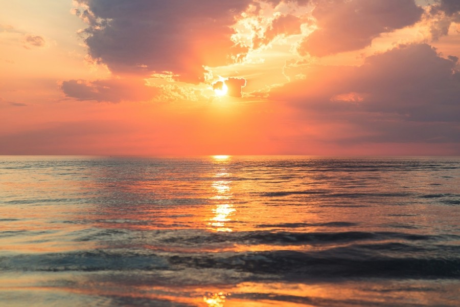 Sunrise over a large body of water.
