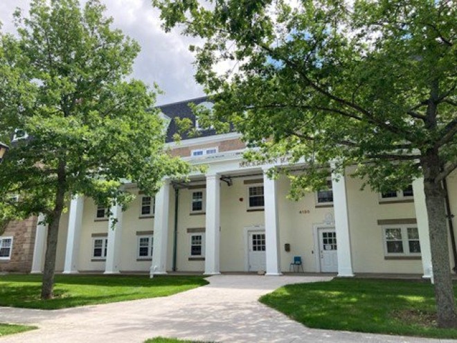 Exterior of MacKinnon Hall entrance on a sunny day 
