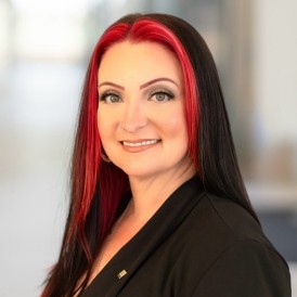 headshot of a white woman with black and red hair